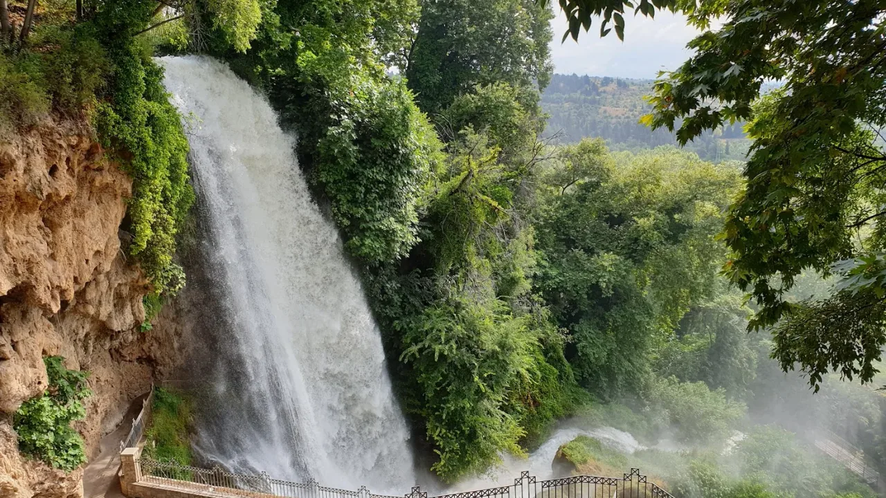 The Karanos waterfall at Edessa plunging over a mossy cliff into green woodland