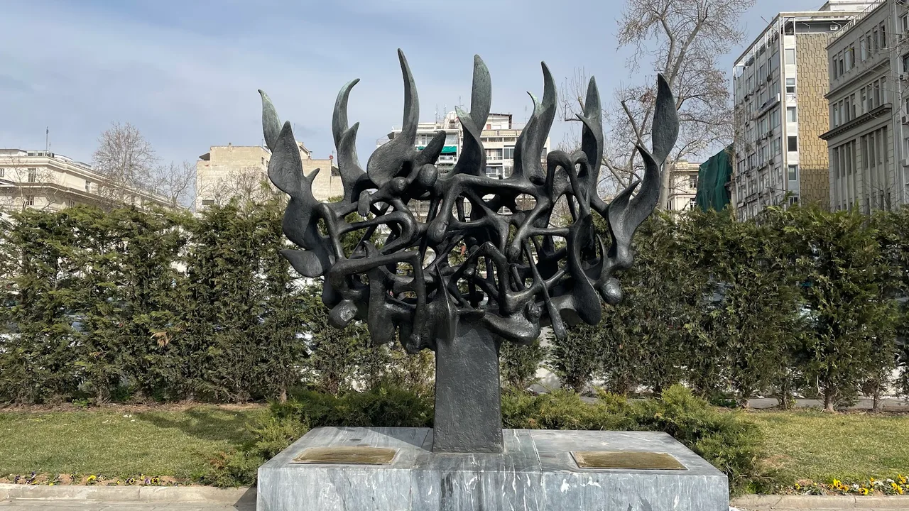 The bronze Holocaust Memorial sculpture of Thessaloniki, a menorah formed of intertwined human figures, on its plinth
