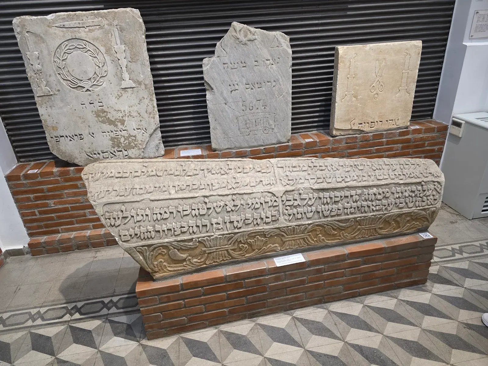 Carved marble tombstones with Hebrew inscriptions, rescued from Thessaloniki's destroyed Jewish cemetery and displayed in the Jewish Museum of Thessaloniki
