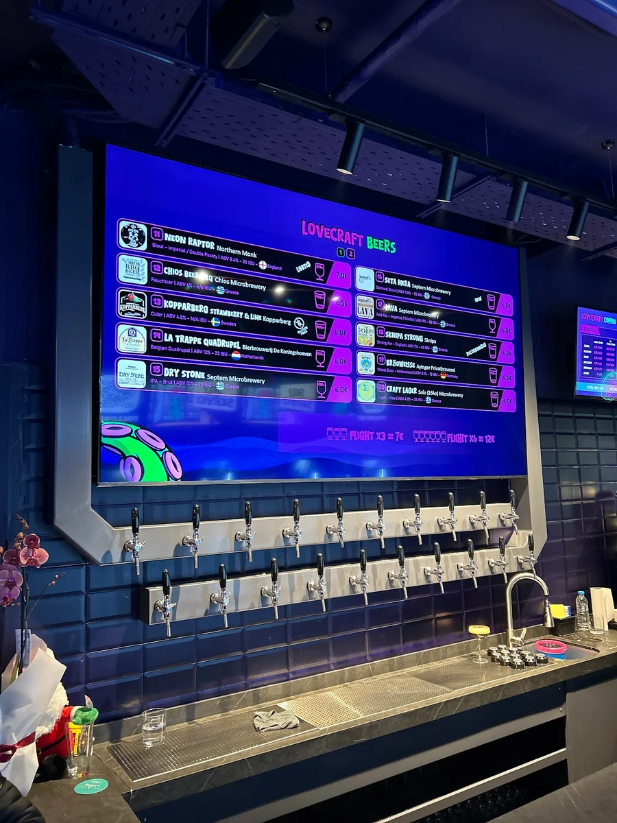 The wall of taps and digital beer menu at LoveCraft Beers, a self-service craft-beer bar near Aristotelous Square, Thessaloniki