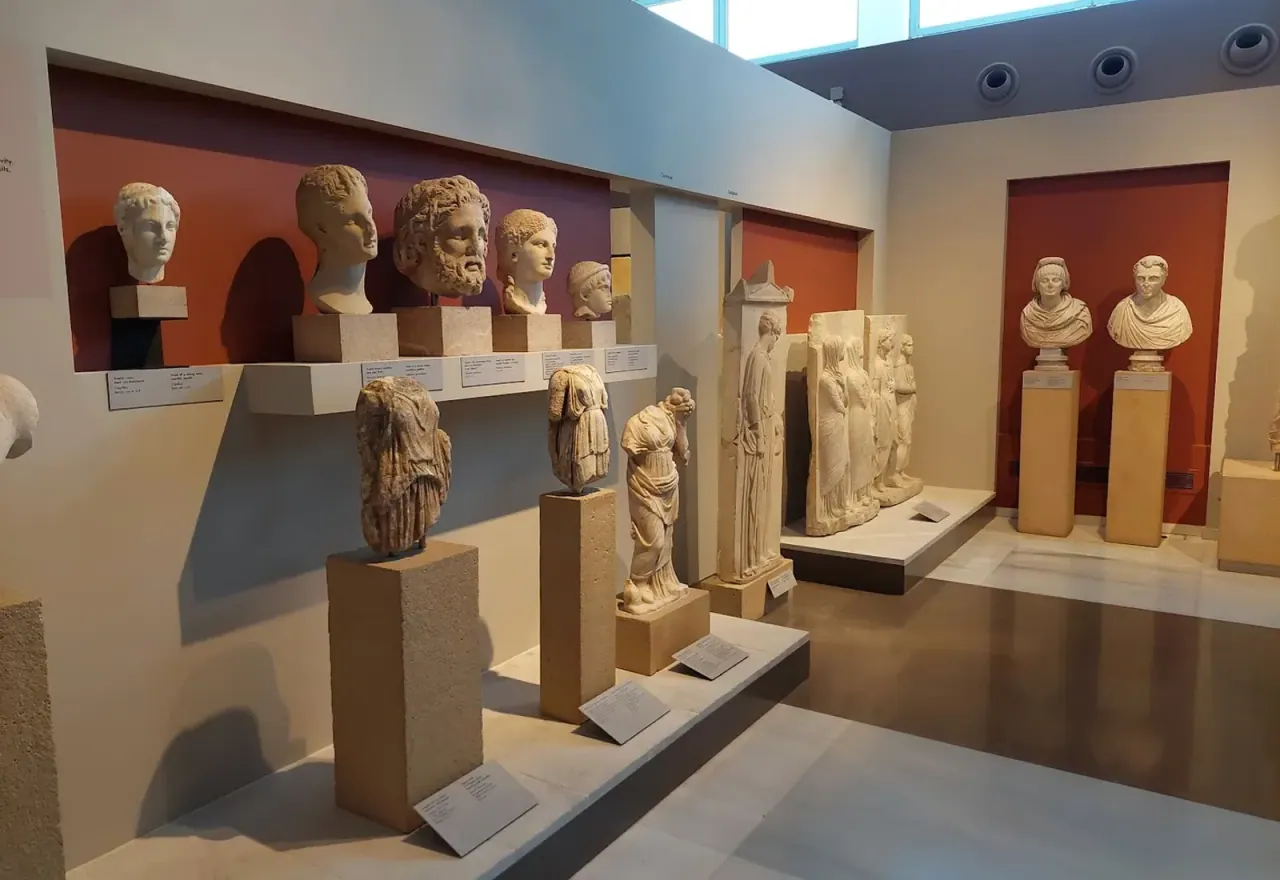 Marble portrait busts and statues in a gallery of the Archaeological Museum of Thessaloniki