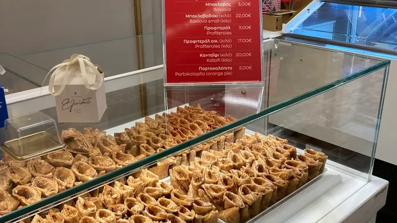 Syrup-soaked trigona phyllo cones filled with custard on display in a Thessaloniki patisserie