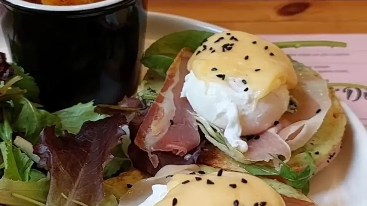 Eggs Benedict with poached eggs, hollandaise and prosciutto on a brunch plate in Thessaloniki