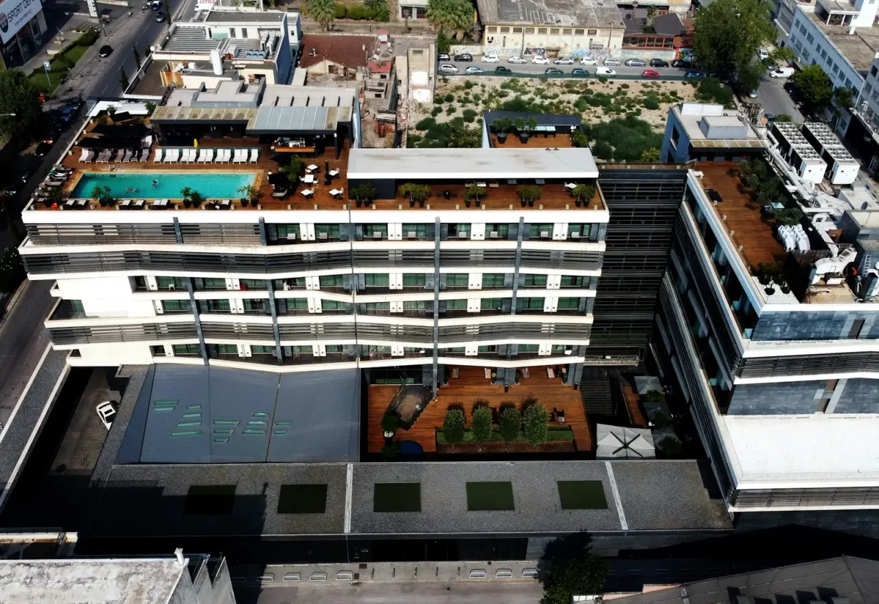 Aerial view of a modern hotel with a rooftop pool in Thessaloniki