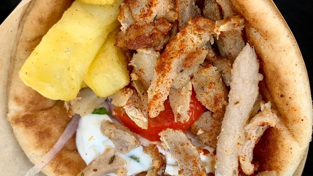 A pork gyros and souvlaki pita with chips at a Thessaloniki souvlaki shop
