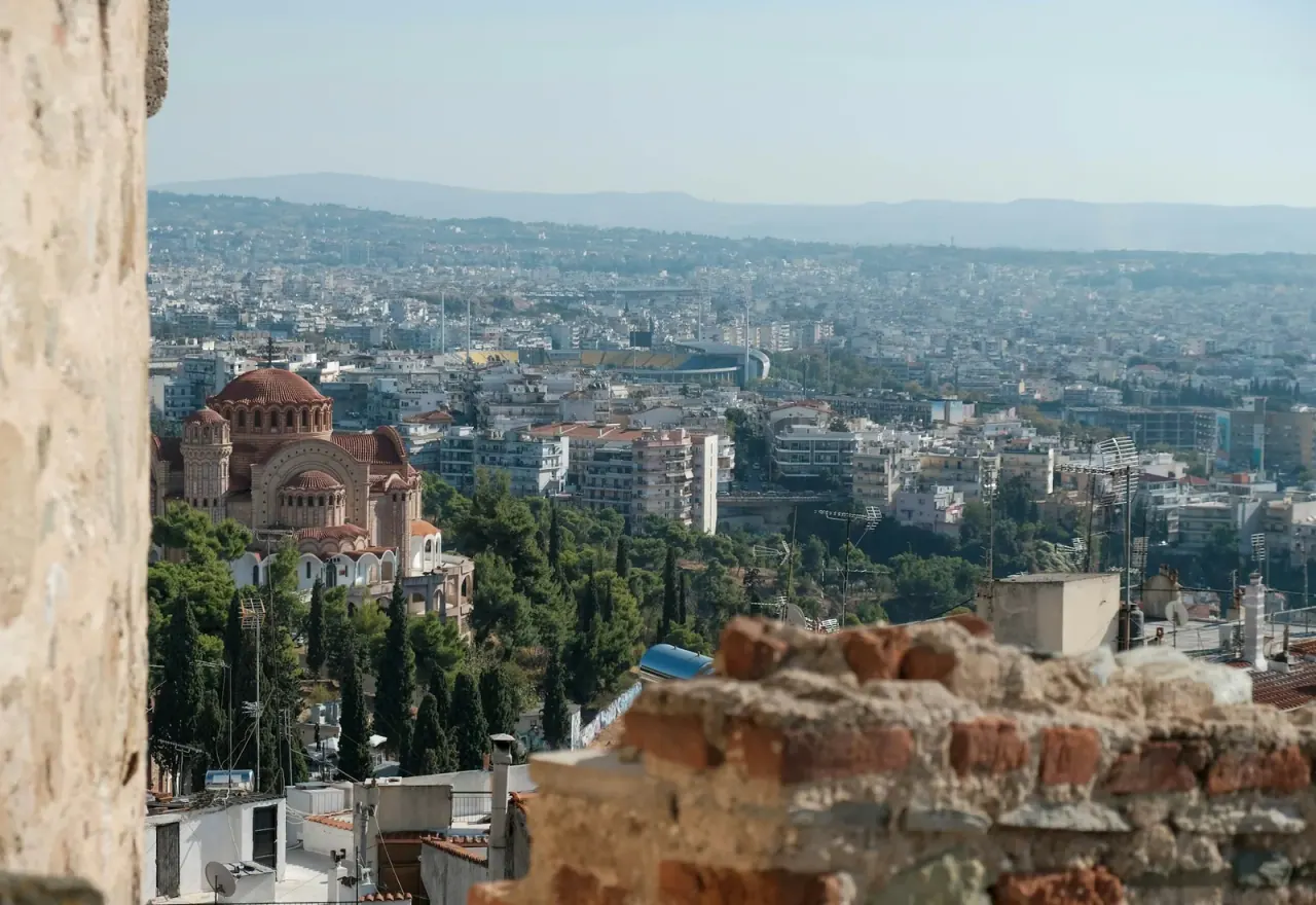 The view over Thessaloniki from the walls of Ano Poli, with a Byzantine church and the city stretching to the hills
