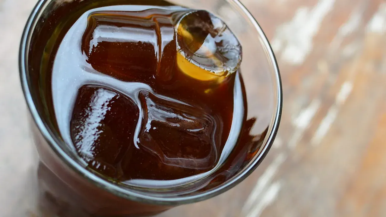 A tall glass of iced coffee over ice — the freddo is the staple of Greek café culture