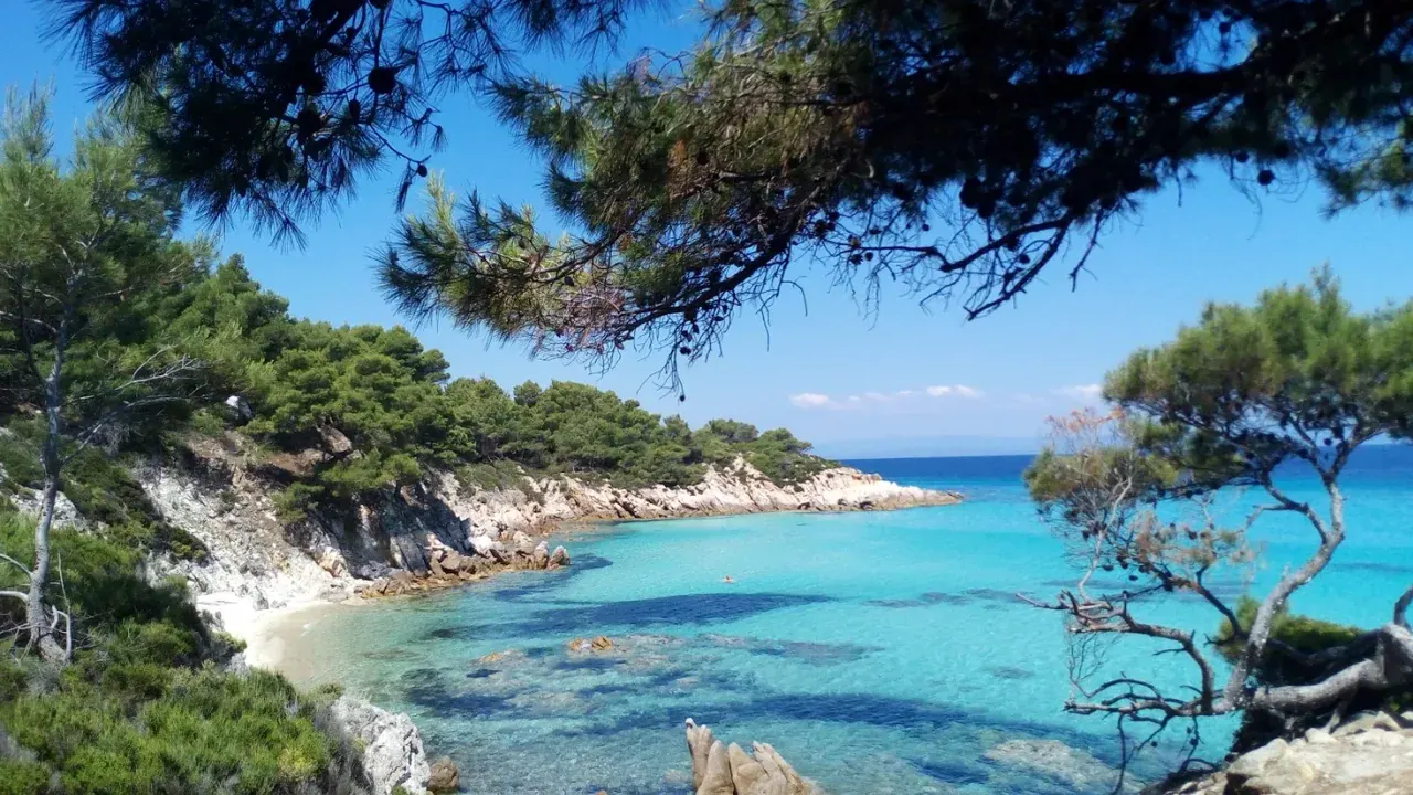 A beach and turquoise sea on a Halkidiki peninsula — the main summer draw reached by KTEL bus from Thessaloniki