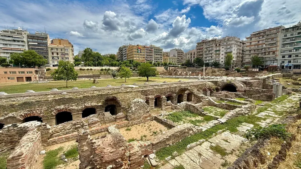The excavated Roman Forum ruins in central Thessaloniki, with modern apartment buildings behind — not a working hammam, but part of the city's long bathing and civic heritage