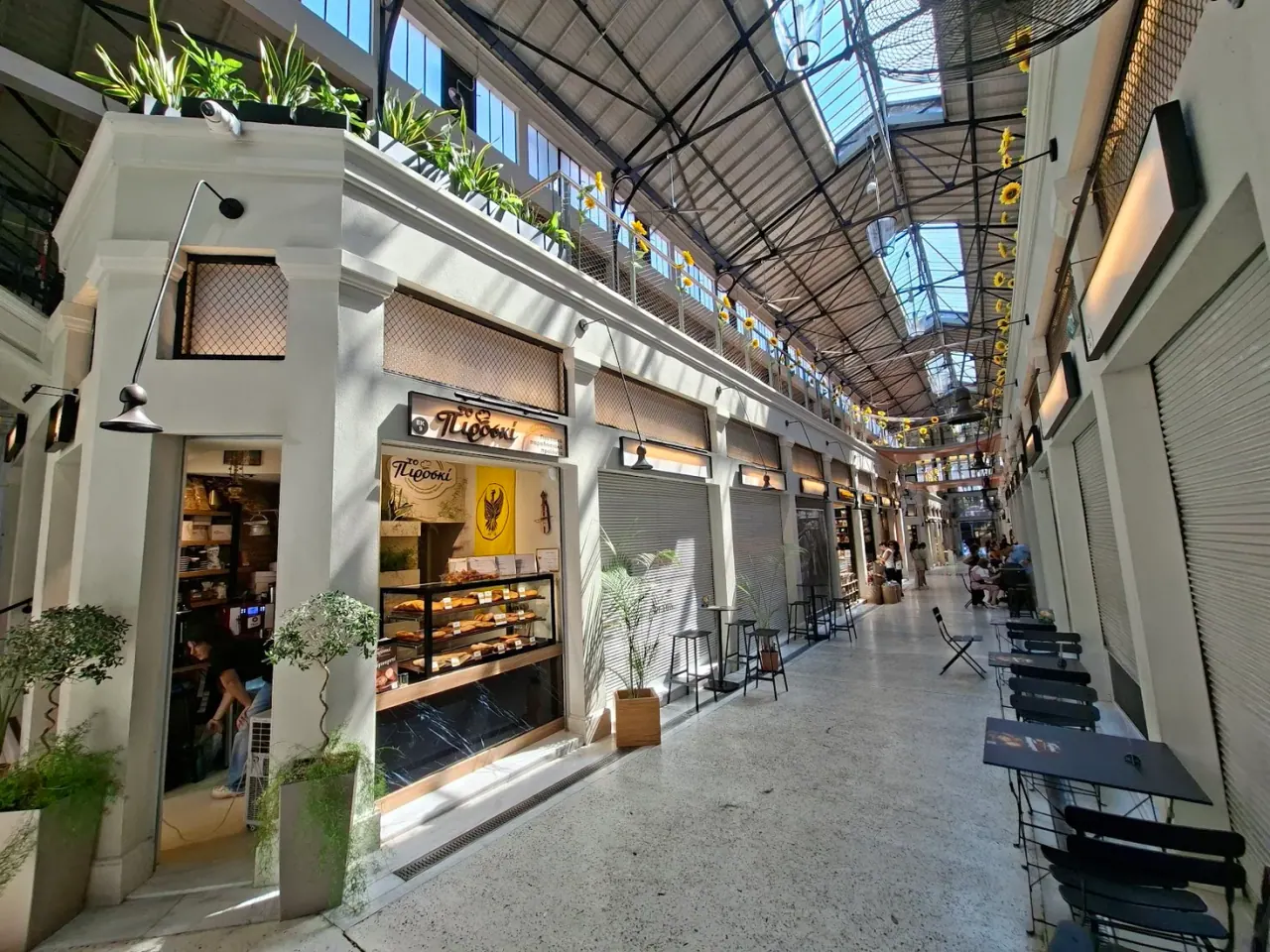 The restored iron-and-glass arcade of Modiano Market in Thessaloniki, lined with food stalls and tavernas