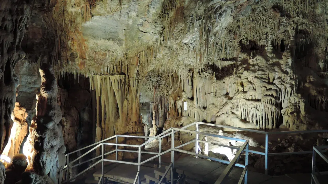 Illuminated stalactites and the visitor walkway inside Petralona Cave in Halkidiki, near Thessaloniki
