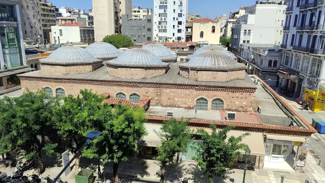 The six lead domes of the Ottoman-era Bezesteni covered market rising above its brick hall in central Thessaloniki