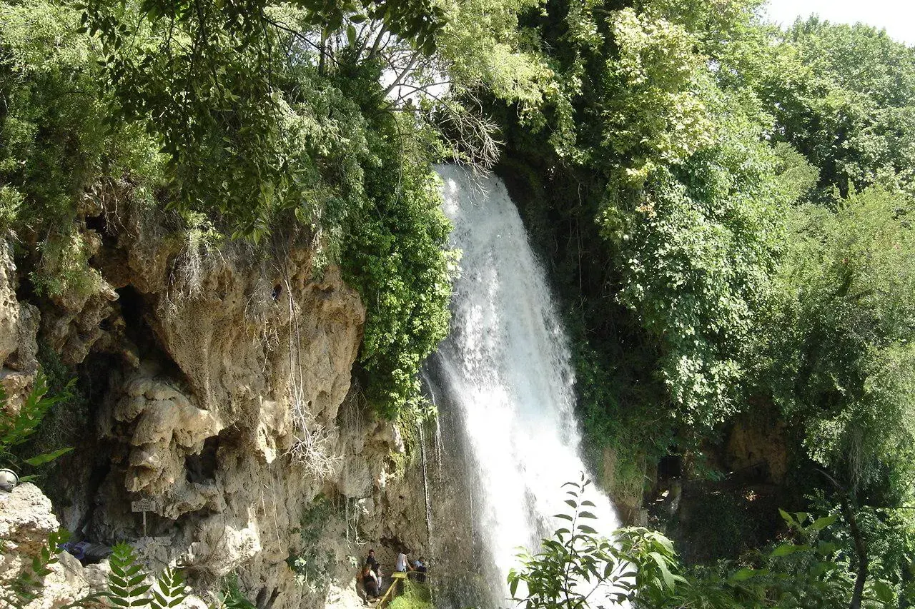 The Edessa waterfall cascading through green woodland