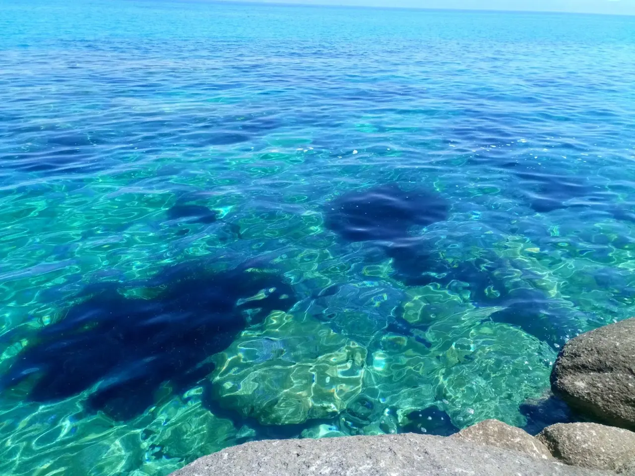 Crystal-clear turquoise water over rocks at Kavourotrypes on the Sithonia peninsula, Halkidiki