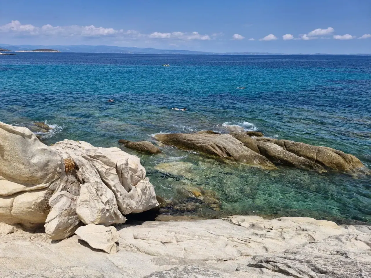 Smooth white rocks and pines above the turquoise bay of Karydi beach at Vourvourou, Sithonia