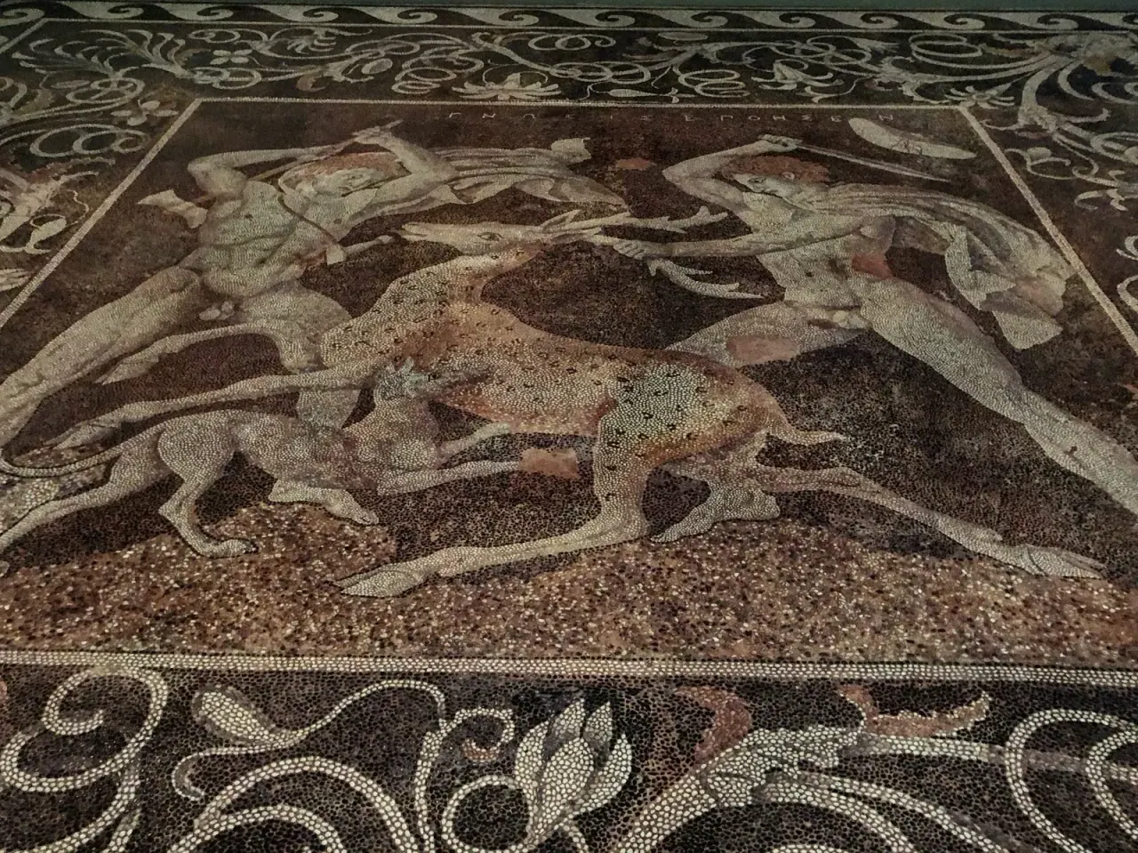 A large figural pebble-mosaic floor on display at Pella