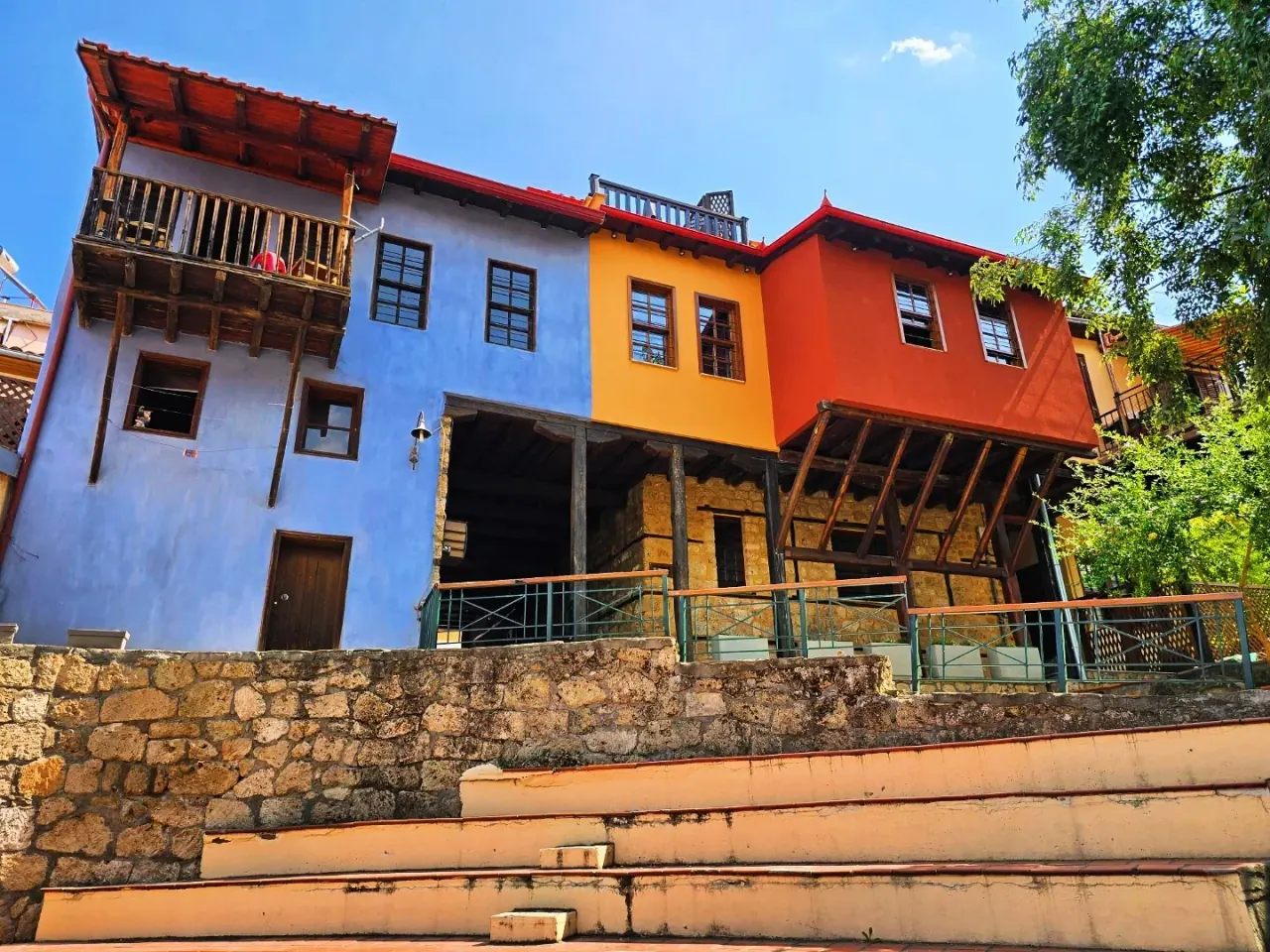The colourful blue, ochre and red timber mansions of Veria's old quarter on stone terraces