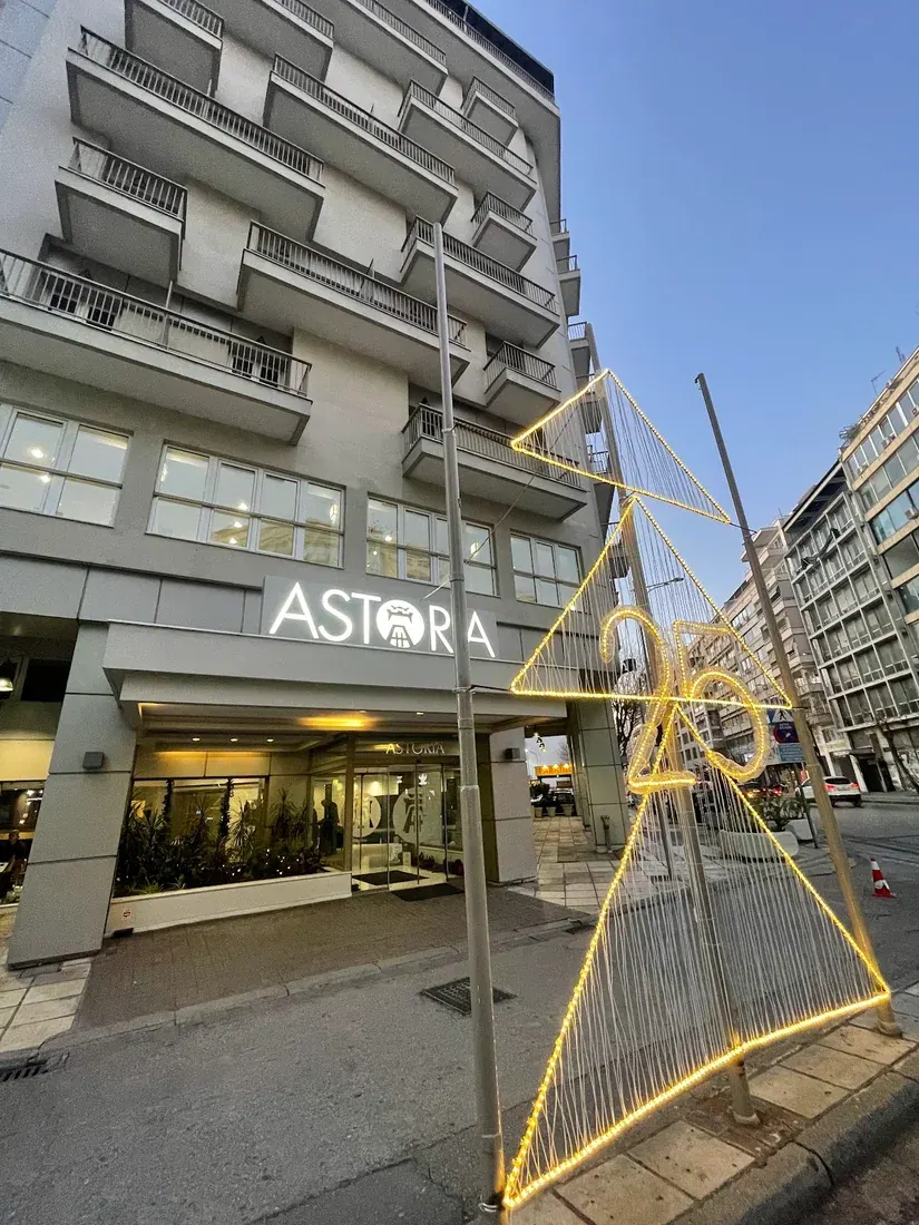 Facade of the Astoria Hotel Thessaloniki with its illuminated ASTORIA sign above the entrance
