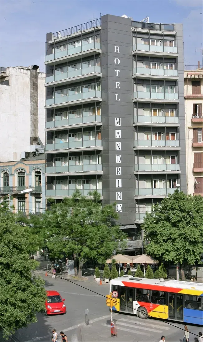 The Mandrino Hotel tower with its vertical HOTEL MANDRINO sign on Antigonidon Square