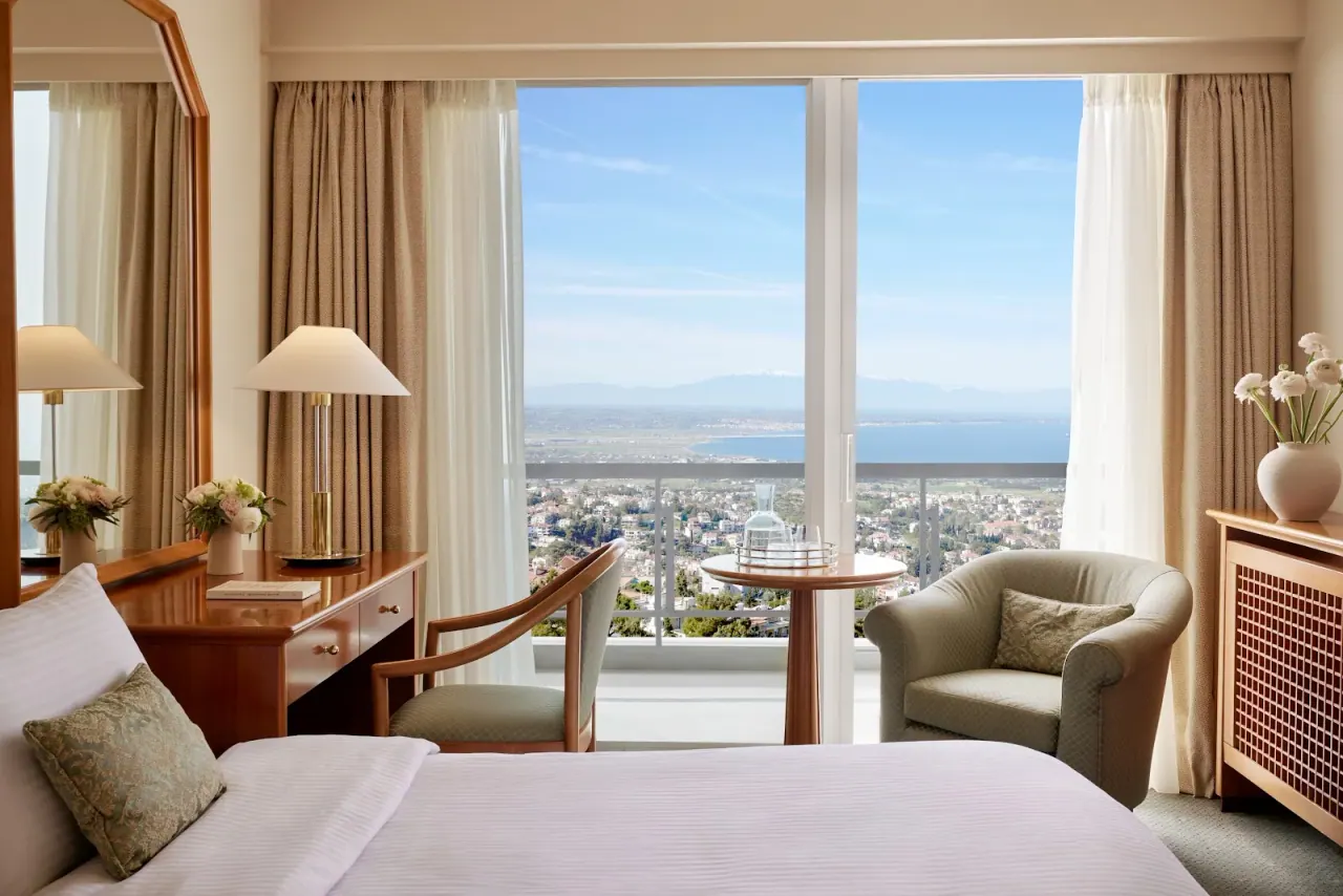 A Panorama Hotel room with a private balcony overlooking the Thermaic Gulf and the city below