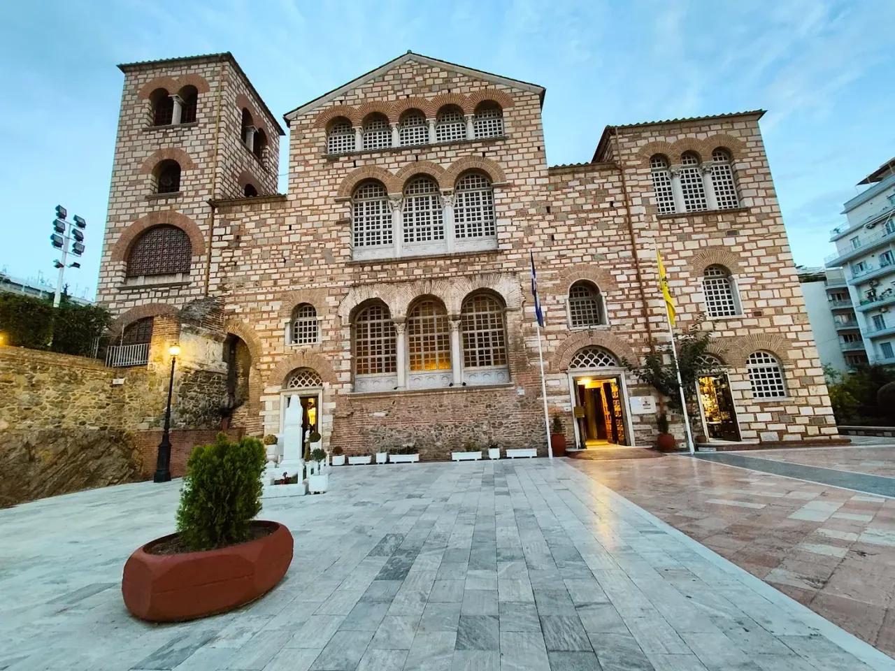 The brick facade and bell tower of the Church of Agios Dimitrios at dusk