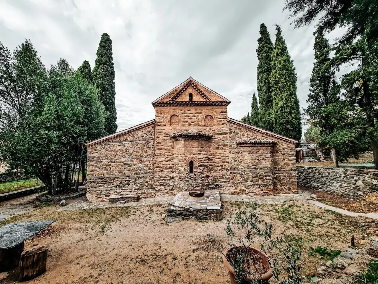 The apse and rear of the Byzantine church of Agios Nikolaos Orfanos among cypress trees, Thessaloniki