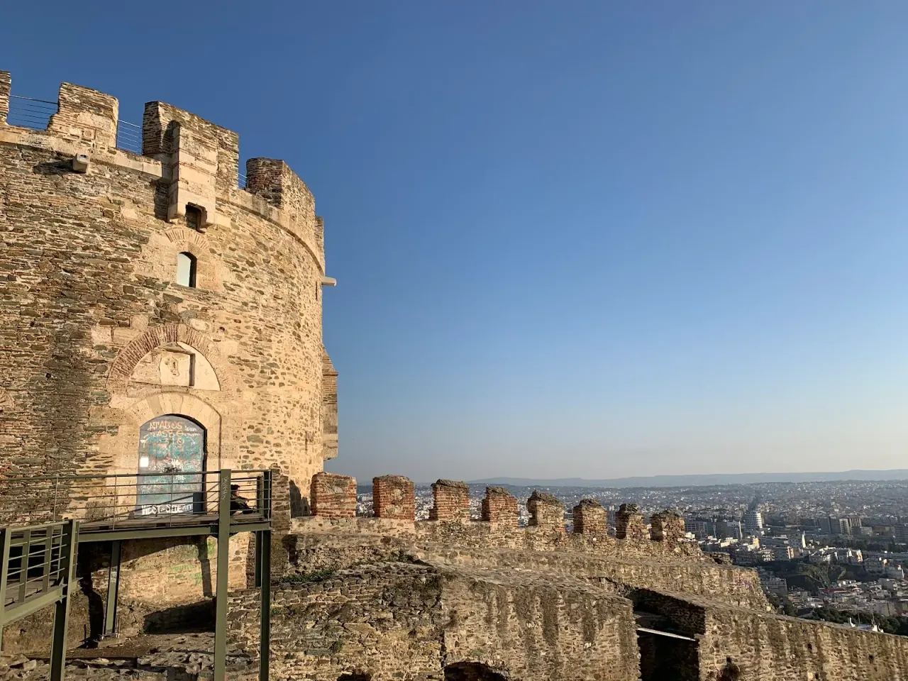 The Byzantine ramparts and a tower of the upper-town walls above Thessaloniki, with the city below