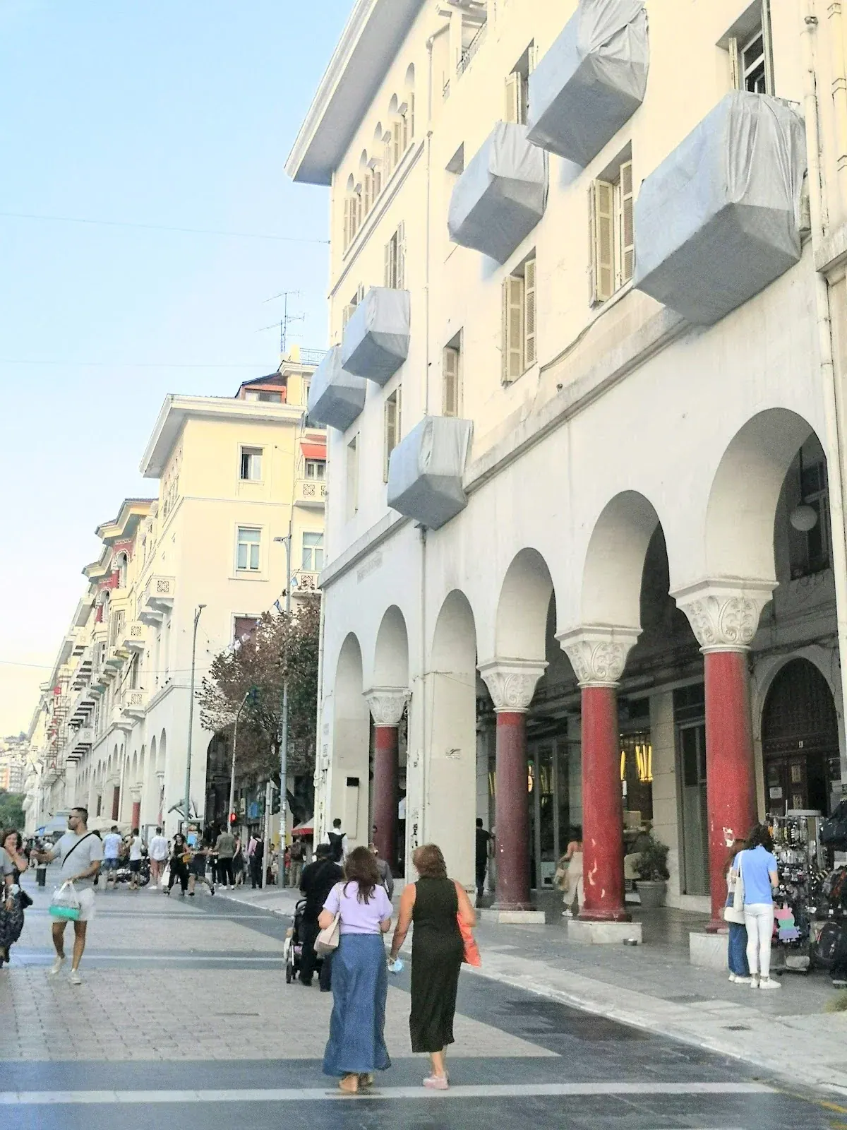 The covered colonnade arcades running along Aristotelous Square