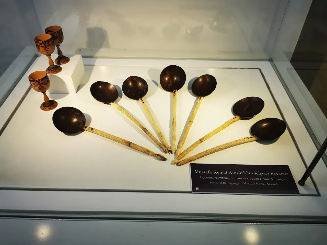 A display case of Ottoman-era fezzes and objects in the Atatürk House museum