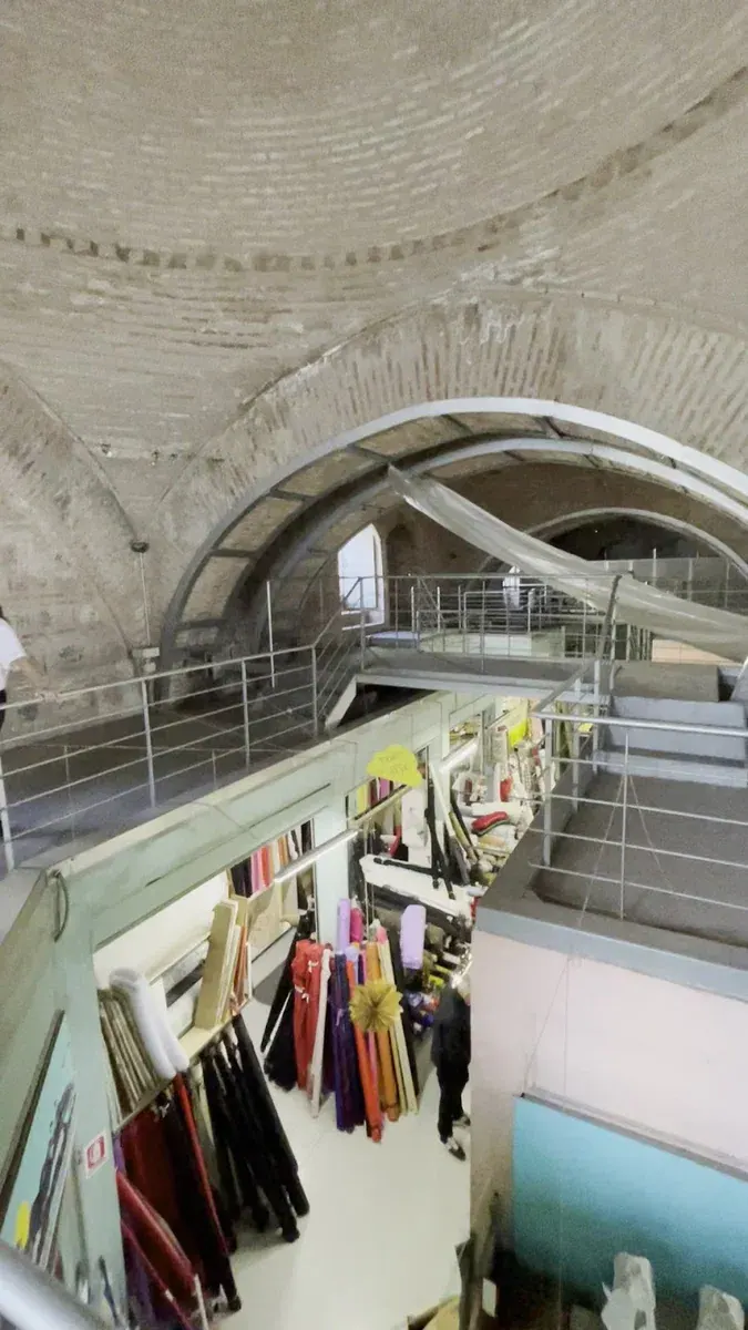 Inside the Bezesteni — brick-vaulted bays above a fabric and textile shop, Thessaloniki