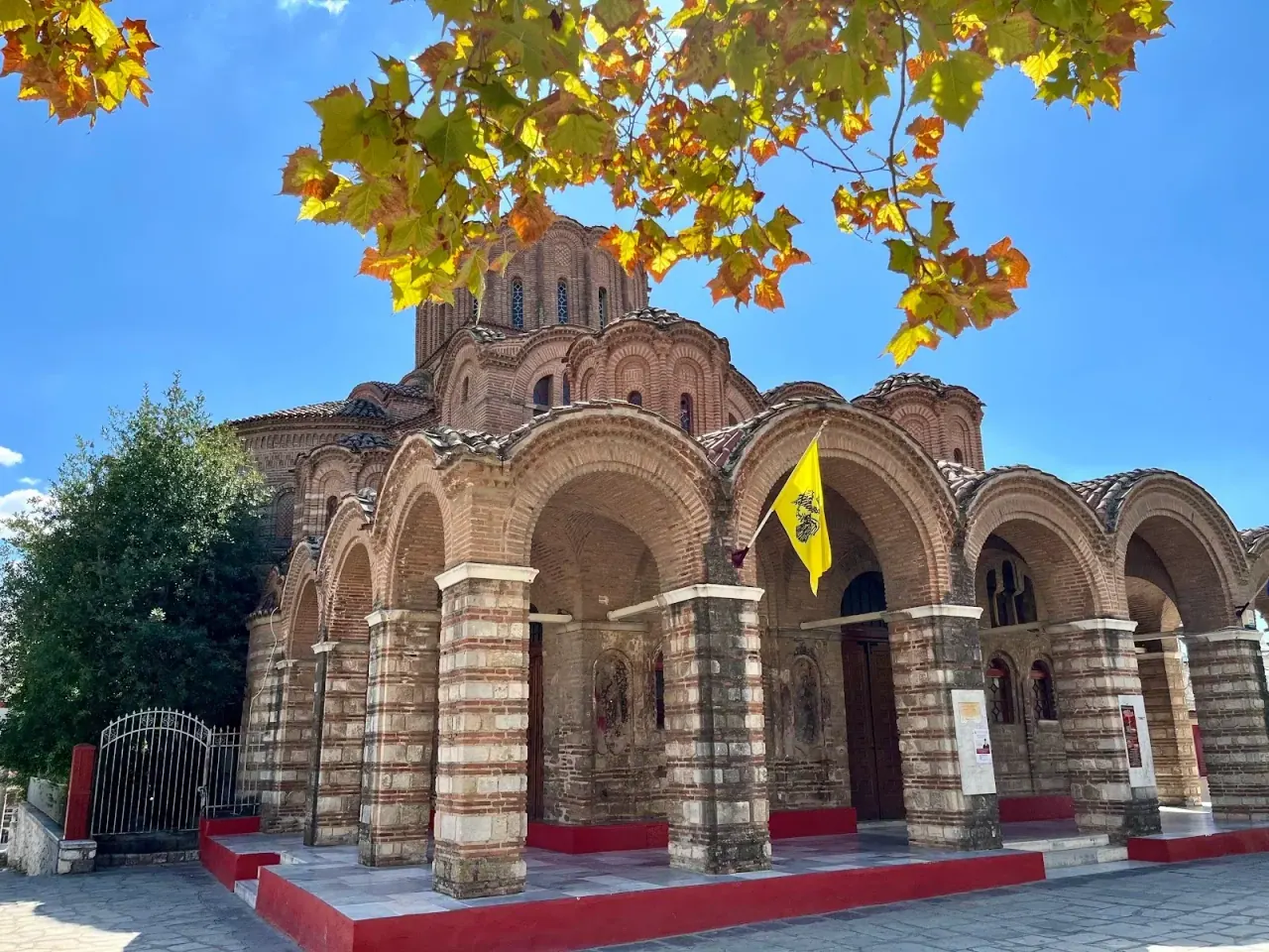 The ornate brick exterior and dome cluster of the 14th-century church of Profitis Ilias, Thessaloniki
