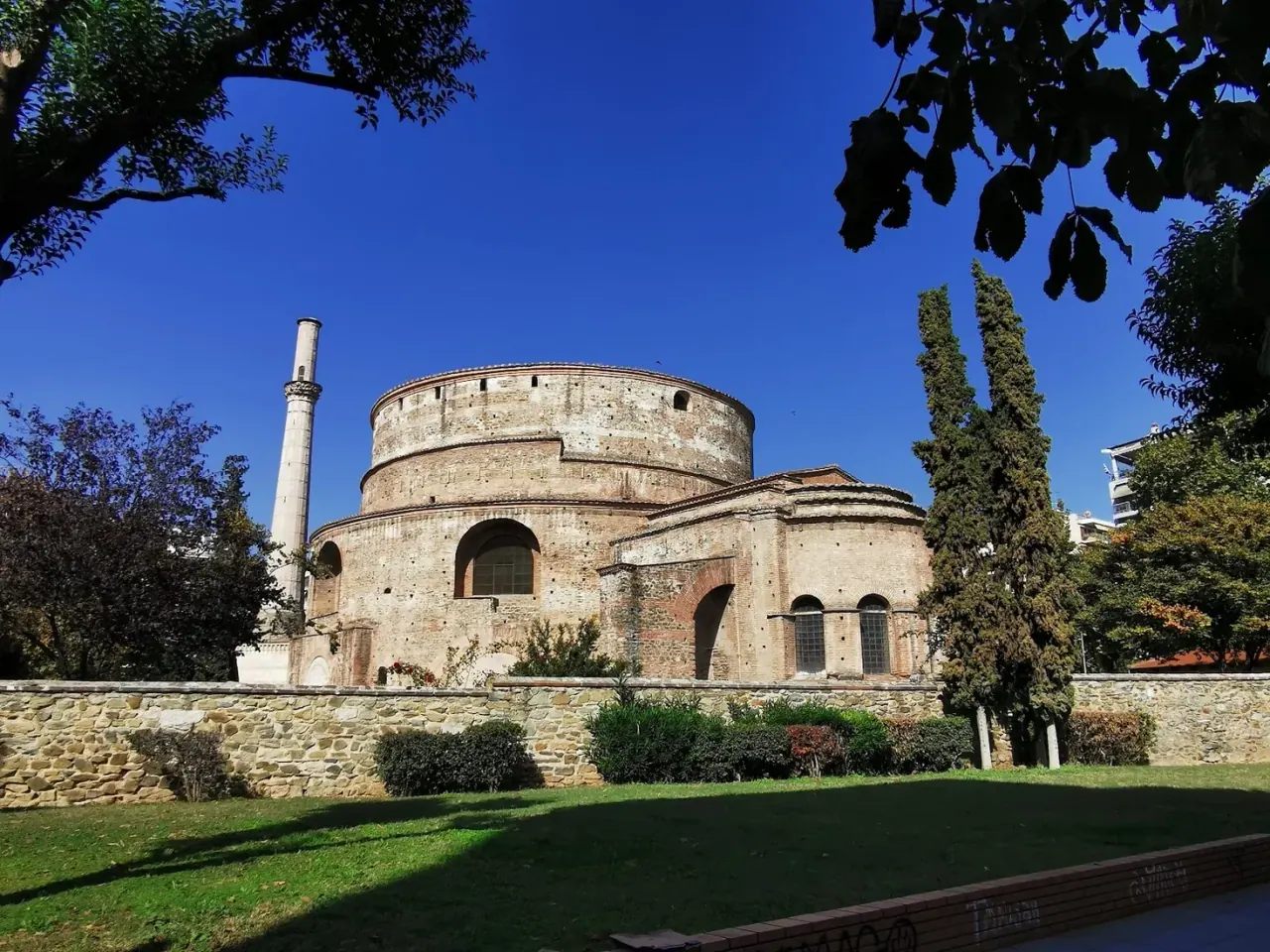 The Rotunda of Galerius and its surviving Ottoman minaret framed by trees in its park, Thessaloniki