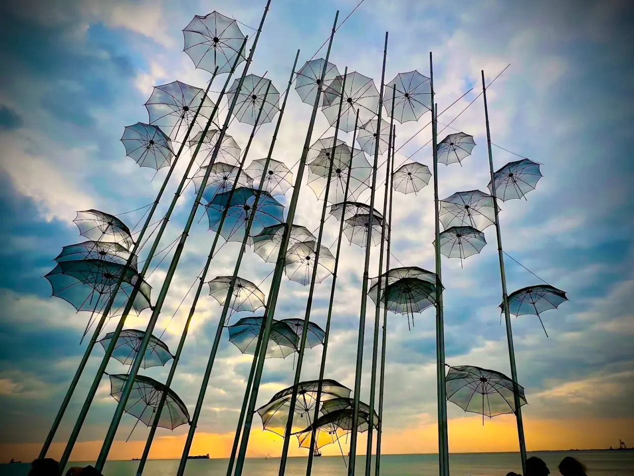 Looking up at the Umbrellas of Zongolopoulos against a dramatic dusk sky on the Thessaloniki seafront