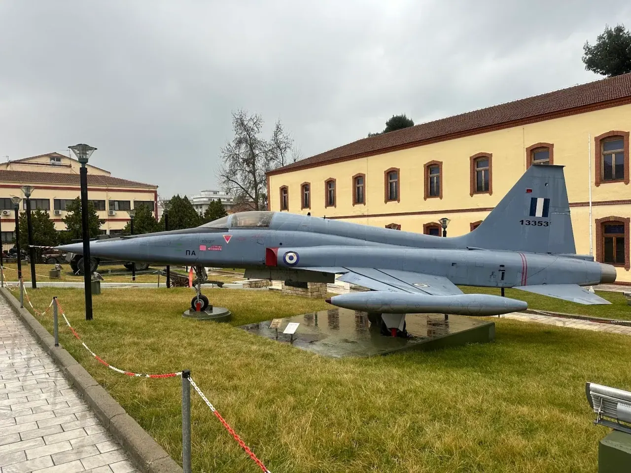 A vintage fighter jet displayed in the courtyard of the War Museum of Thessaloniki