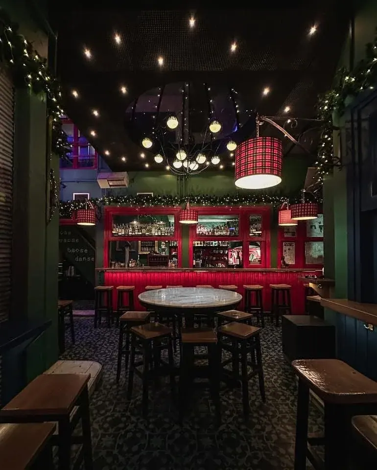 The red-and-green bar and chandelier-lit back room of Notre Dome cocktail bar in the Byzantine Arcade off Valaoritou, Thessaloniki