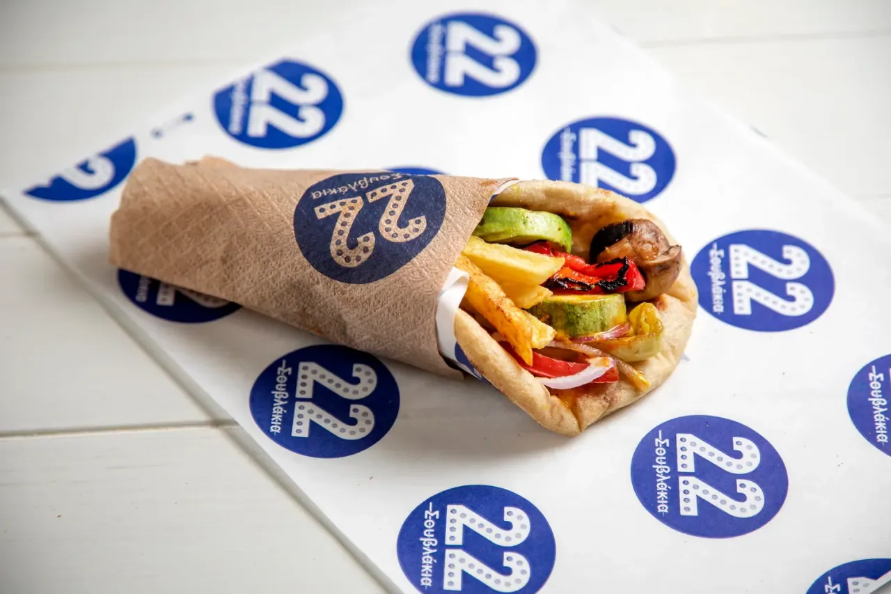 A grilled-vegetable and chips pita wrap on 22 Souvlakia branded paper, Aristotelous Square, Thessaloniki