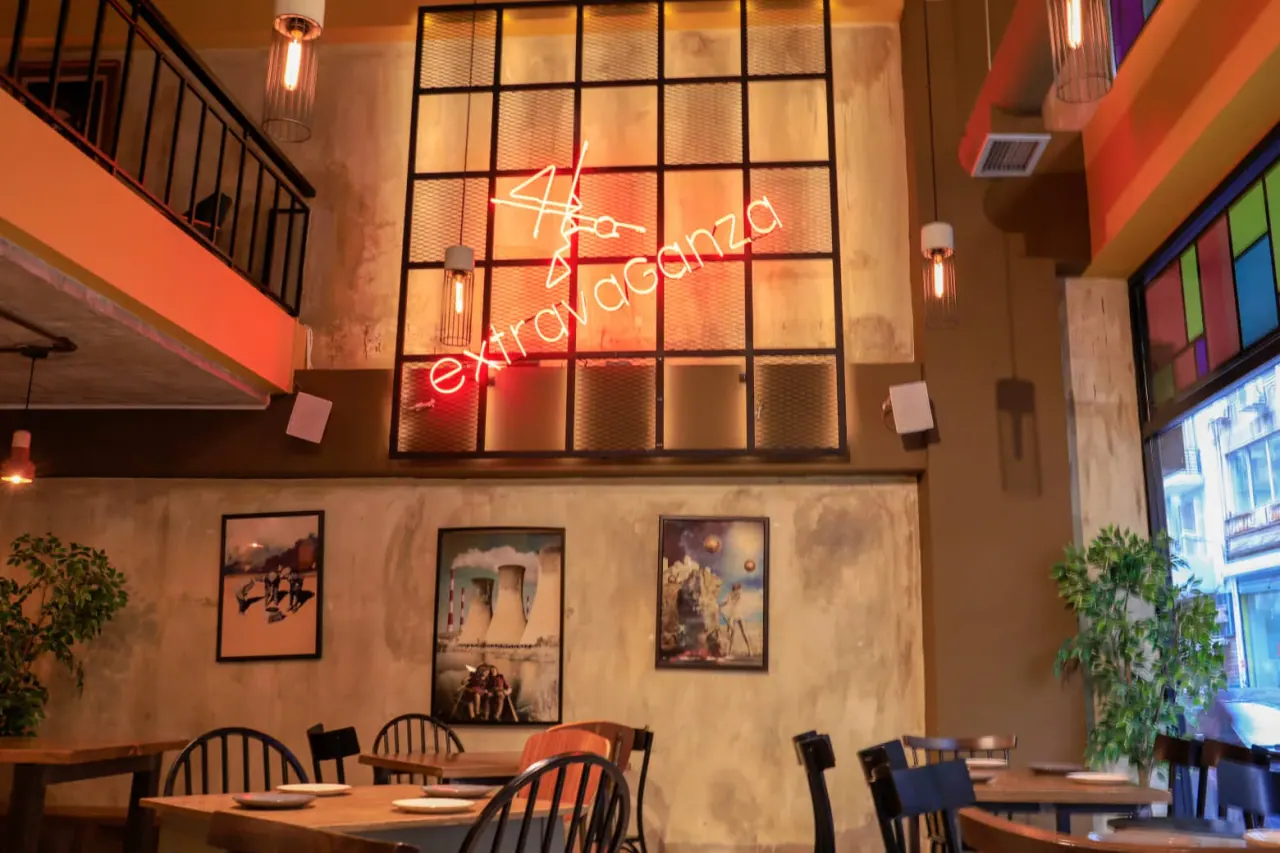 The double-height dining room of Extravaganza with its red neon sign and surreal artwork, near Valaoritou, Thessaloniki