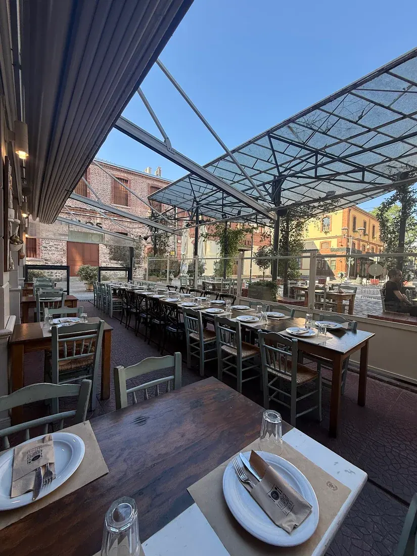The glass-roofed terrace of Kioupia set among the brick buildings near Valaoritou, Thessaloniki