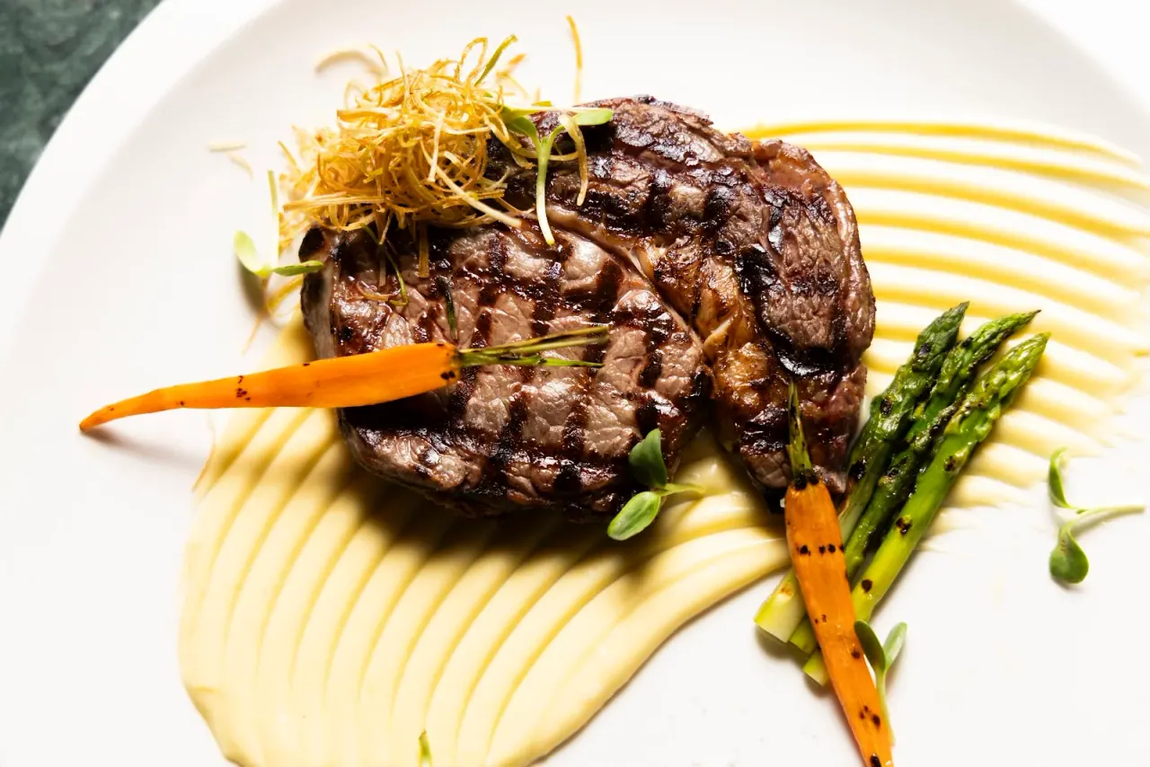 A chargrilled beef fillet over parsnip purée with baby carrot and asparagus at Marrone, Kalamaria, Thessaloniki