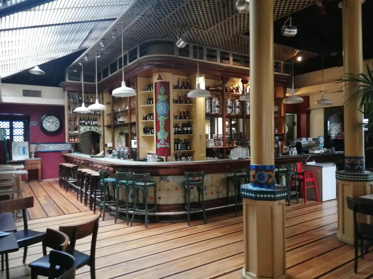 The historic curved wooden bar of Panellinion under its high glazed roof, Ladadika, Thessaloniki