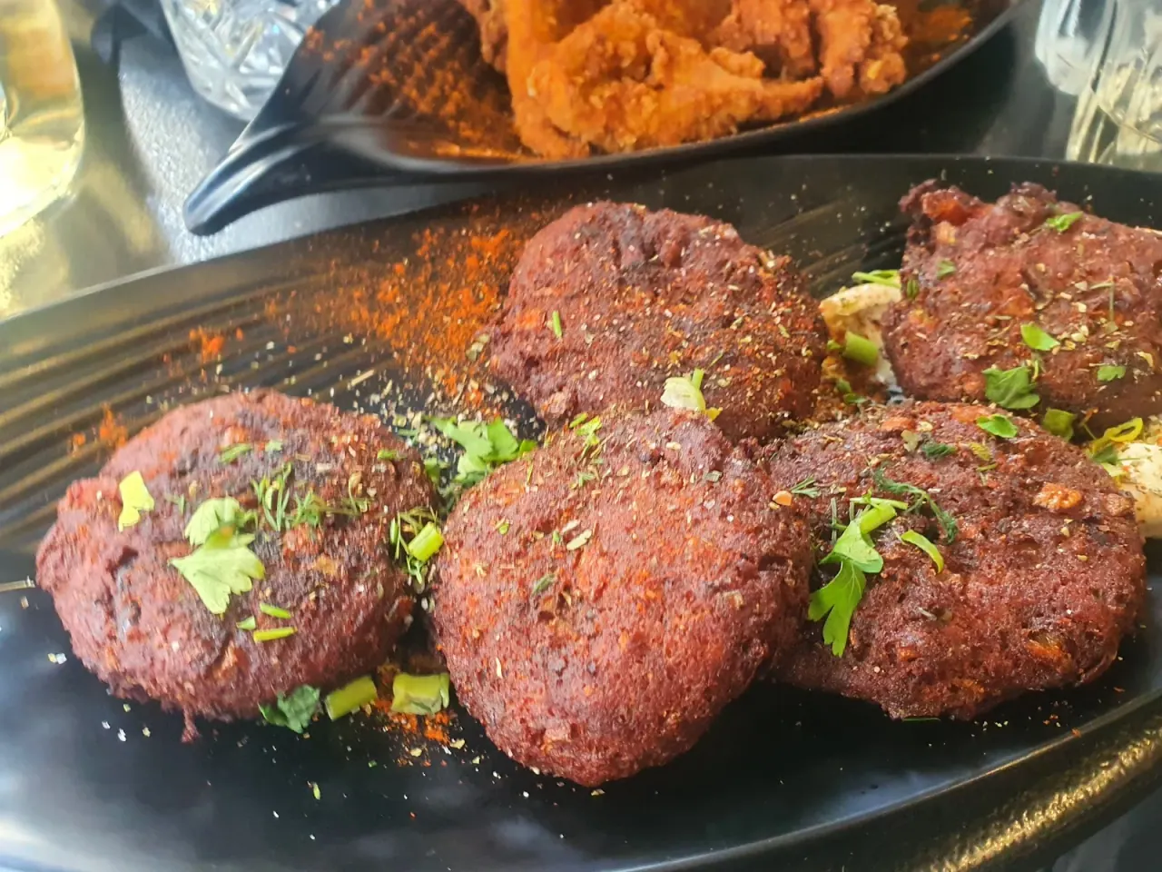 A plate of vegan beetroot keftedes (patties) dusted with herbs at Tarantoúla, Thessaloniki