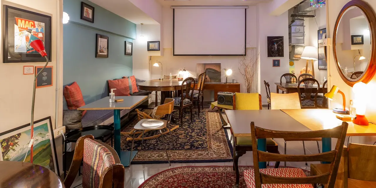 Vintage-styled interior with rugs and framed prints at The Caravan Cafe brunch spot in central Thessaloniki