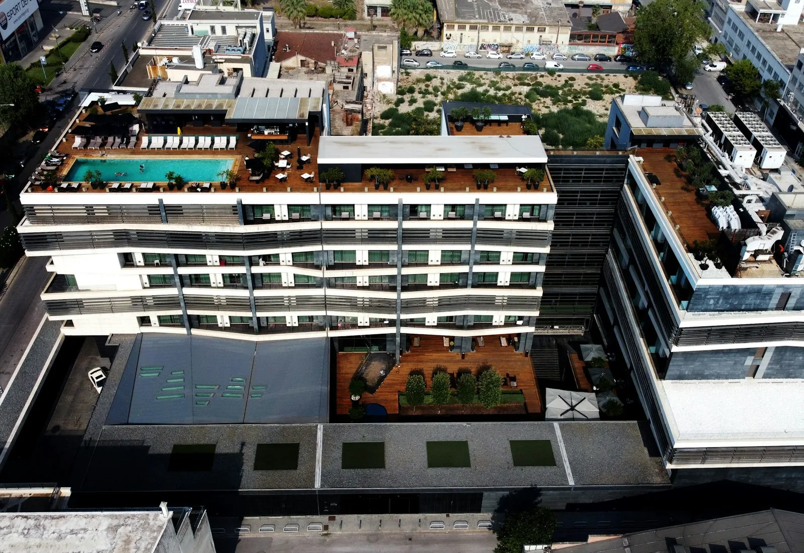 Aerial view of a modern hotel with a rooftop pool in Thessaloniki
