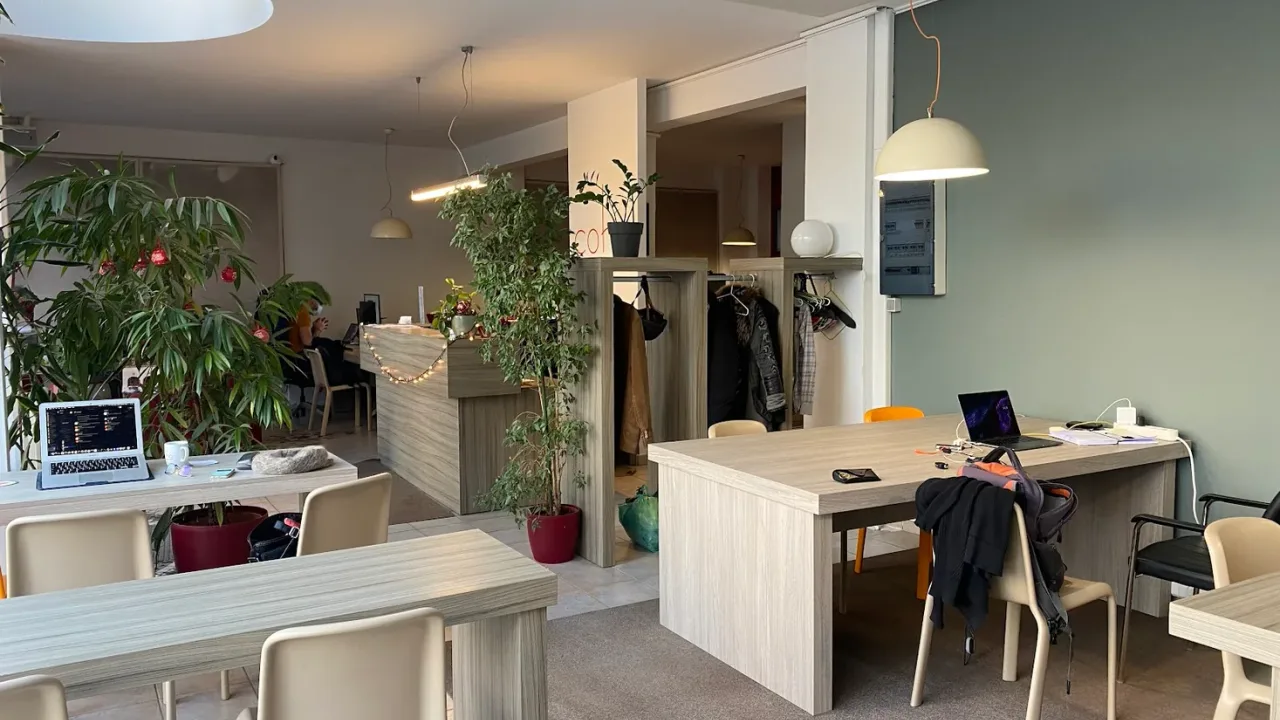 A bright coworking space with shared desks and plants in Thessaloniki