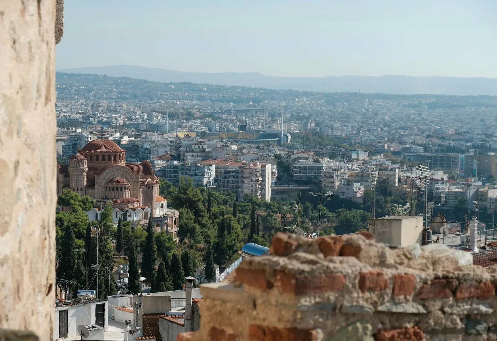 The view over Thessaloniki from the walls of Ano Poli, with a Byzantine church and the city stretching to the hills