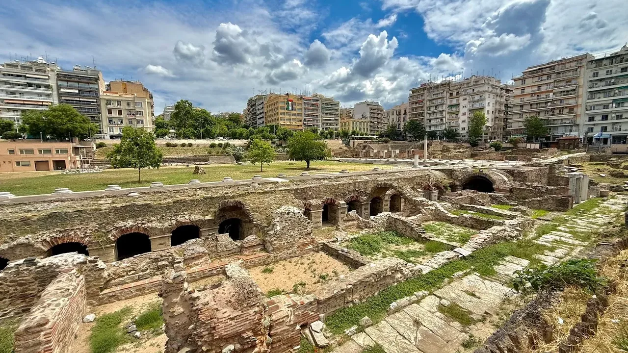 The excavated Roman Forum ruins in central Thessaloniki, with modern apartment buildings behind — not a working hammam, but part of the city's long bathing and civic heritage