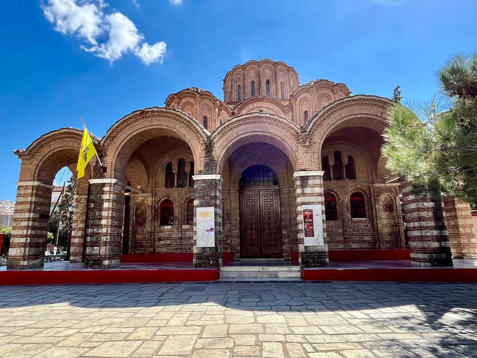 The arcaded portico and brick facade of the Byzantine church of Profitis Ilias (Prophet Elijah), Thessaloniki, with its central dome behind