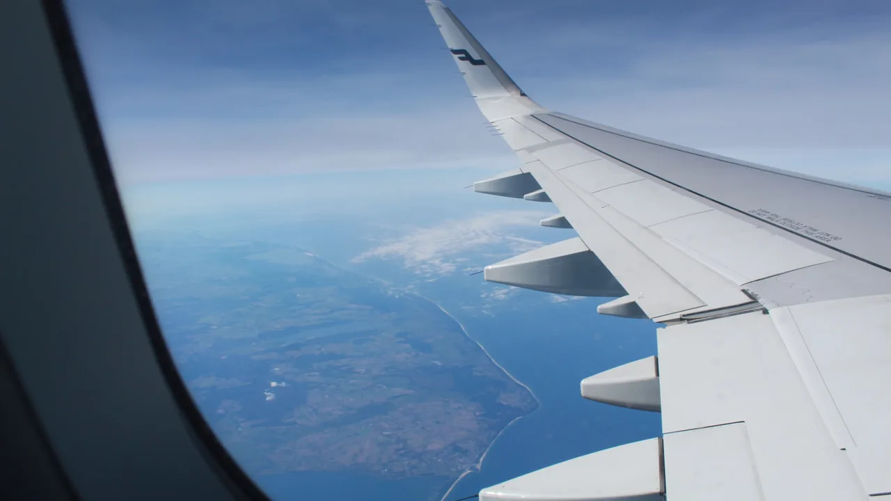 The view of a coastline from an airplane window on approach