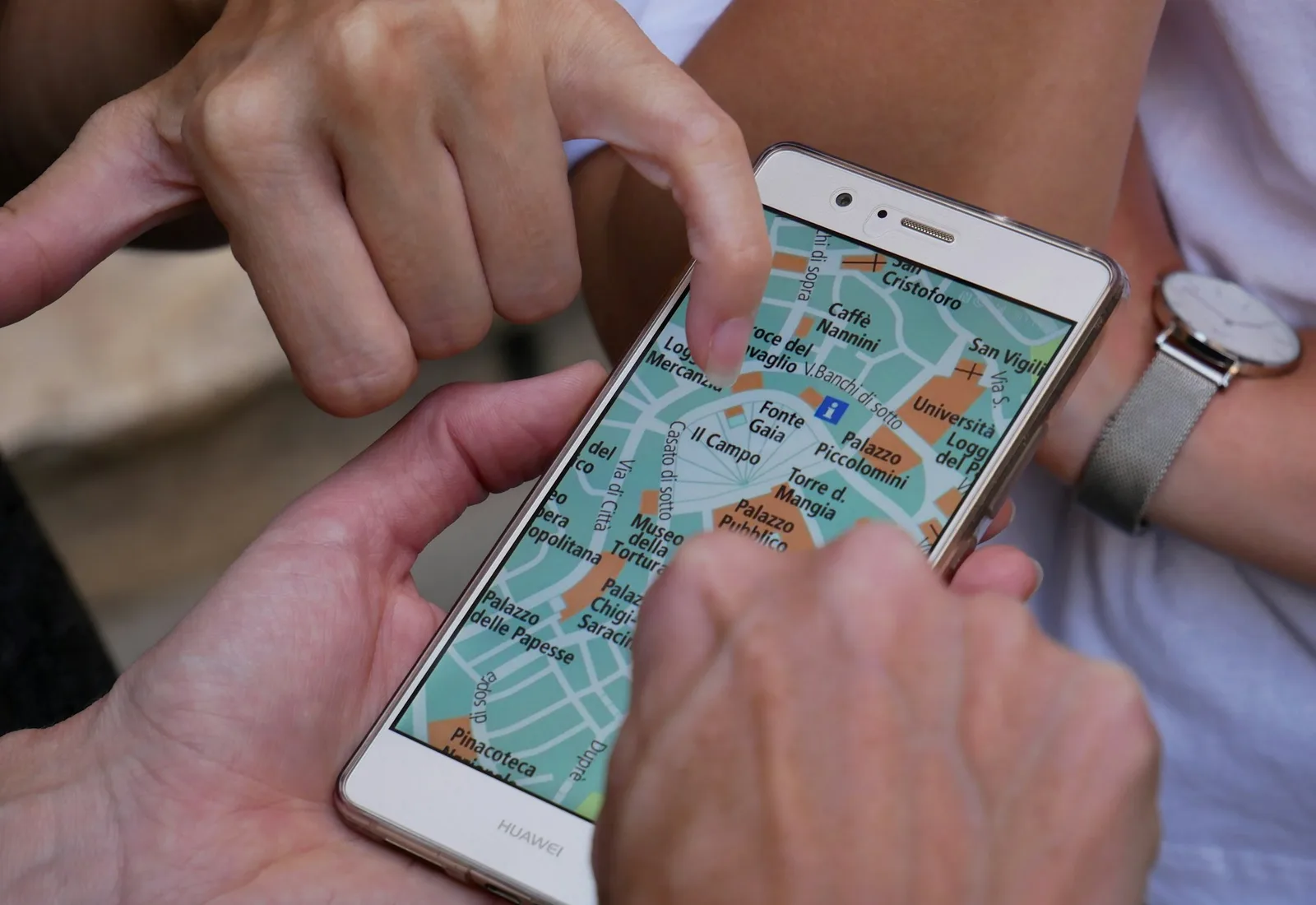 Travellers using a phone map on the go