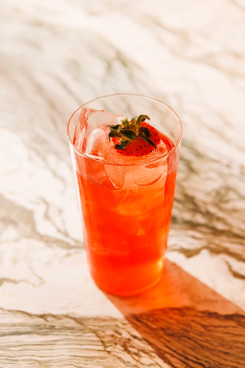 A strawberry cocktail over ice on a marble table at Cin Cin cocktail bar, Thessaloniki